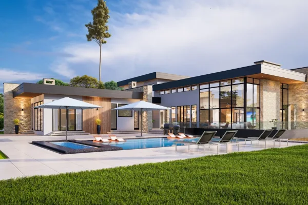a modern house with a pool and lounge chairs